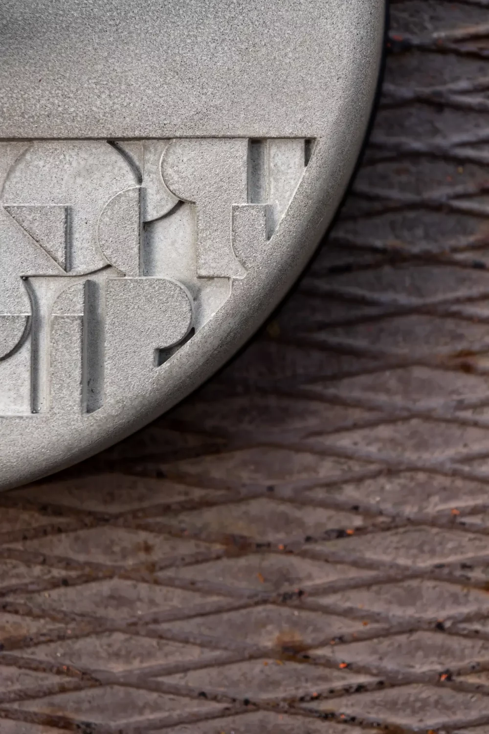 a glimpse of the Brutalist-inspired bas-relief pattern molded into the concrete ballast