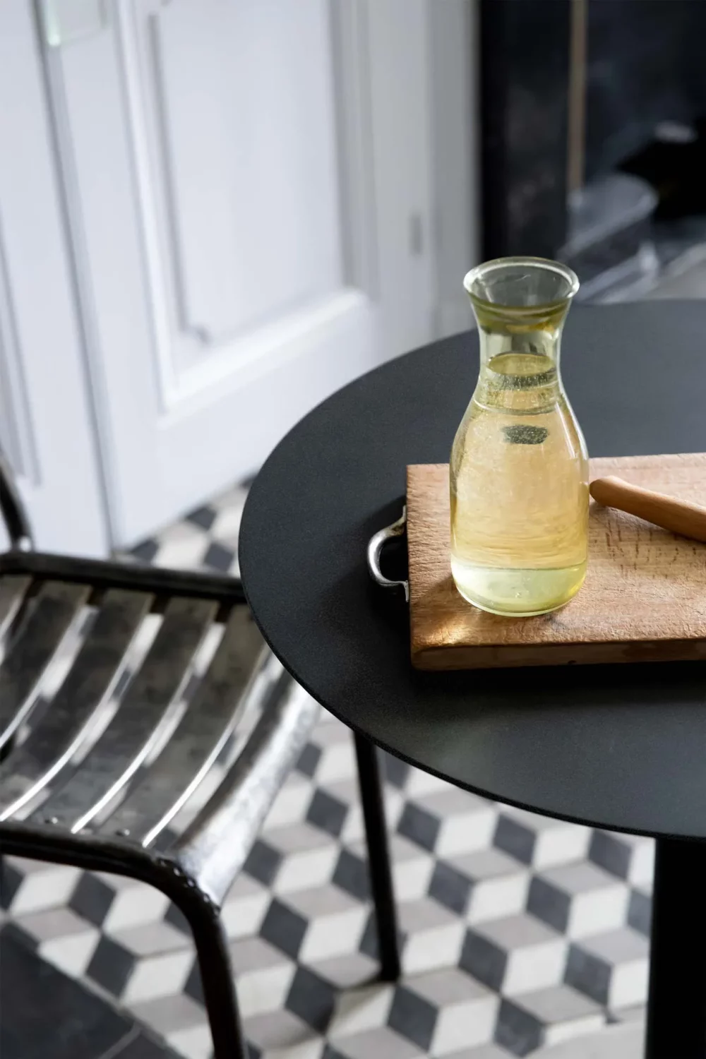 a wooden cutting board placed on the top of the Donut bistro table