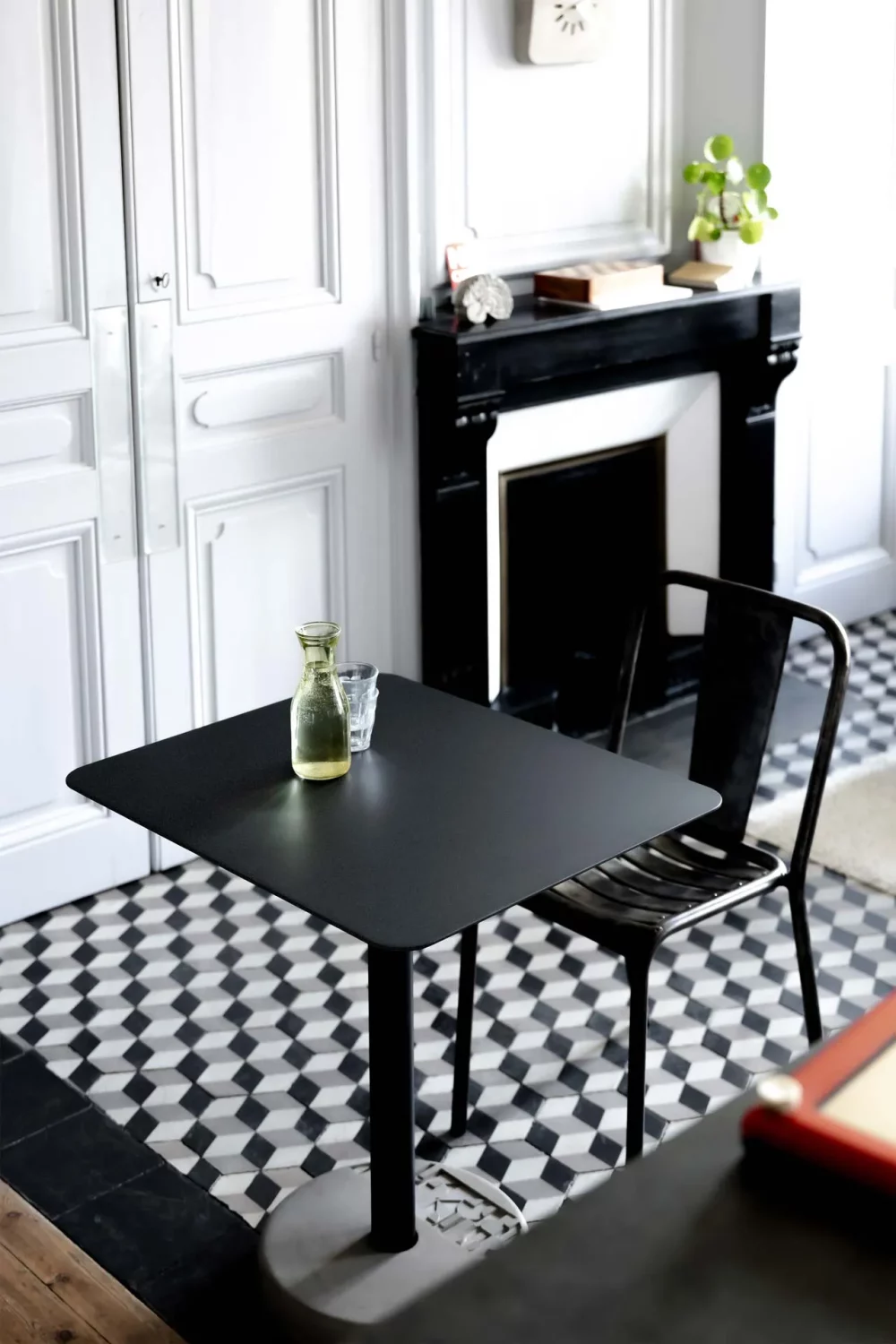 The Donut rectangular table next to a black marble fireplace