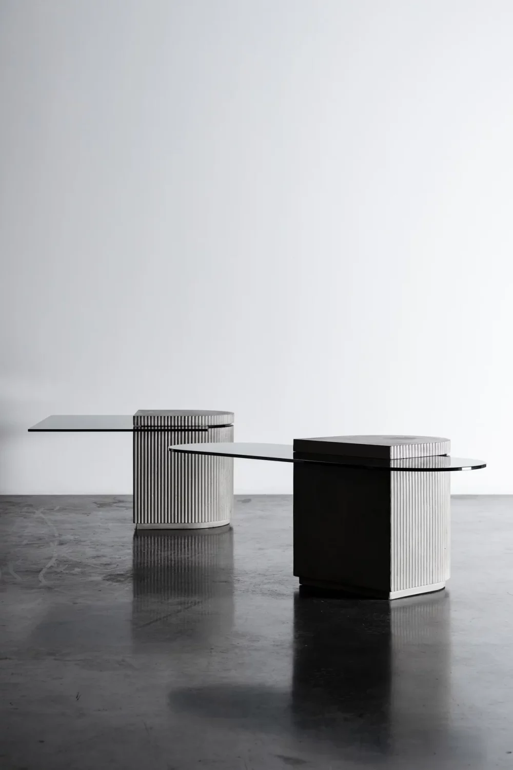 Concrete and hybrid glass cabinet between a coffee table and an extra table