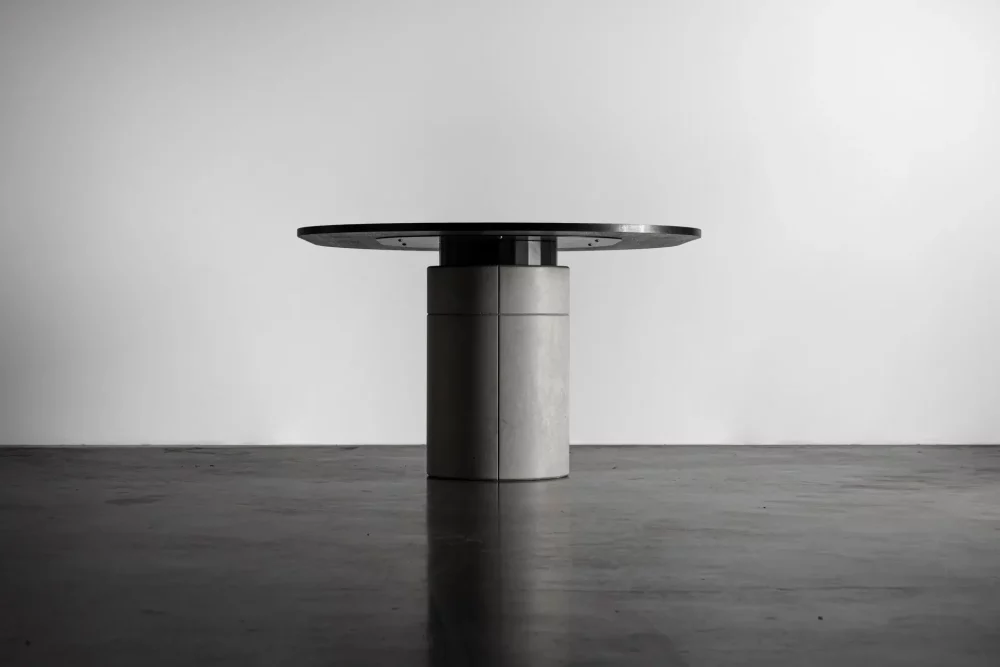 Brutalist detail of the concrete shell which covers the metal foot of the Sharp dining table by designer Bertrand Jayr